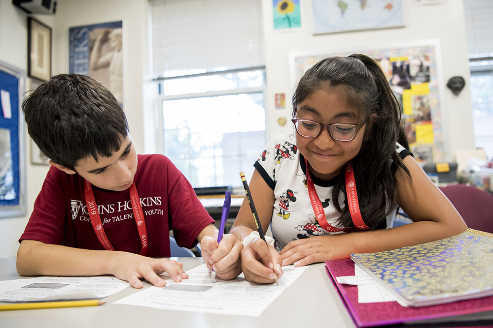 Two CTY students in a classroom working on a paper together