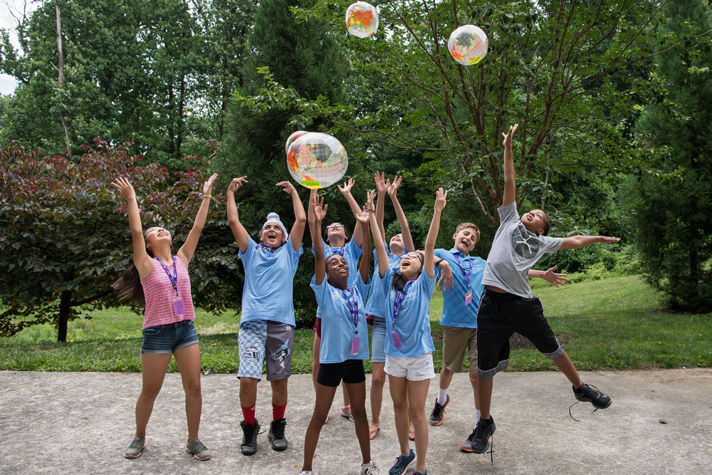 a group of CTY students outdoors playing with balls that look like globes