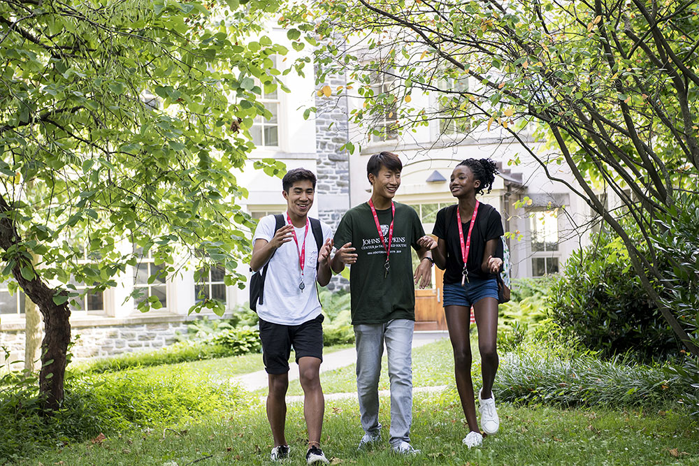 Three CTY students walking and talking on-campus