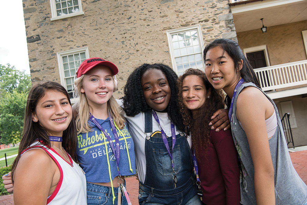 A group of female CTY students at an on-campus site, smiling