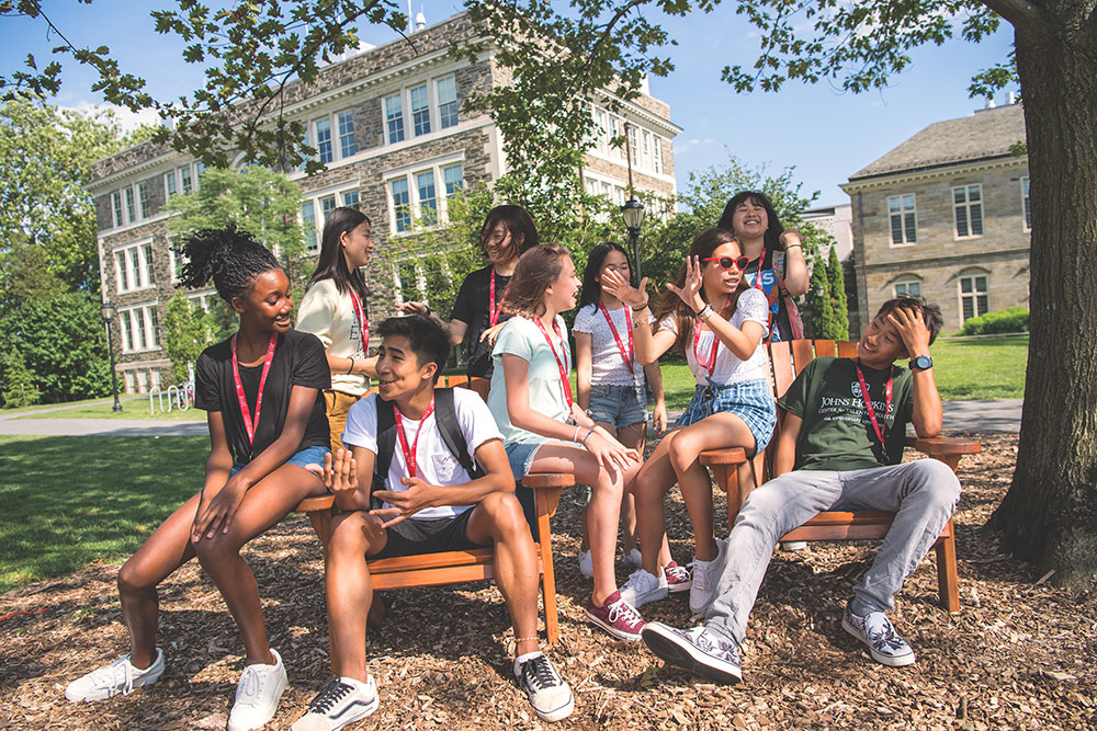 Group of CTY students under a tree at an on-campus site