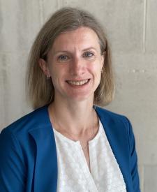 Image of Rachel Gibson wearing a white blouse and blue blazer.