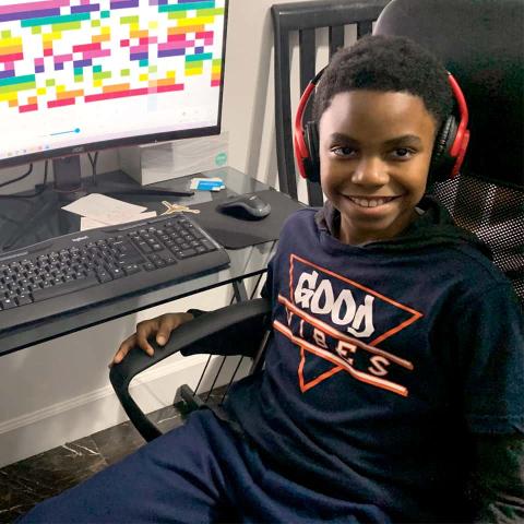 research on teaching and learning of nature of science CTY Online Programs student sitting at computer, wearing headphones