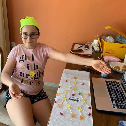 research on teaching and learning of nature of science CTY Online Programs student showing the glucose molecule she created using lolipops