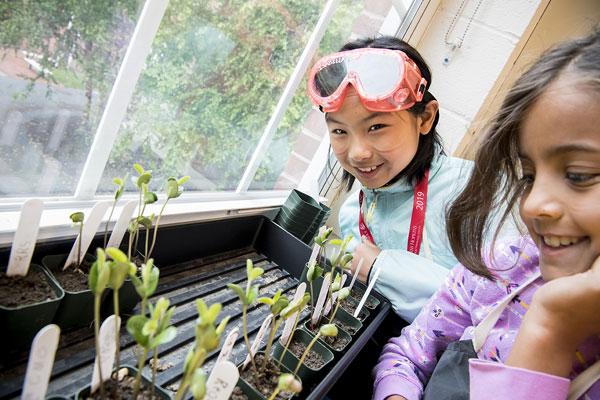 2 CTY students looking at seedlings