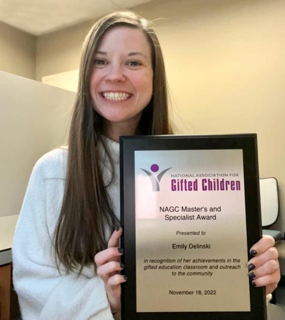 Emily Delinski holding her NAGC award plaque.