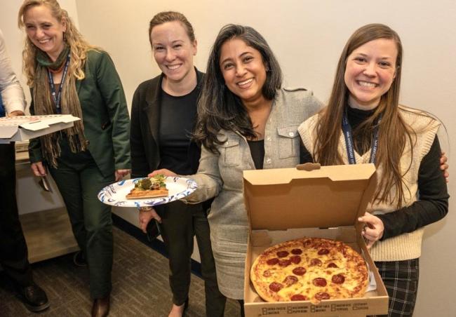 left to right: CTY executive director Amy Shelton, Tricia Schellenbach, Arpan Munier, and Emily Delinski enjoy some Pi Day pizza. 