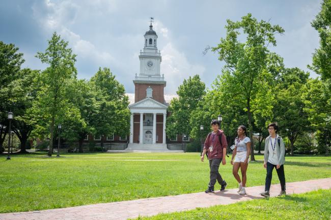 Three older CTY students walking outside on the Johns Hopkins University campus